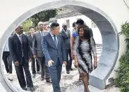  ??  ?? The new Ambassador of The People’s Republic of China to Jamaica Tian Qi (front left) walks with Lady Allen (front right), patron of the Chinese Garden, through the Moon Gate in the Chinese Garden during their recent tour of the exotic space located at...