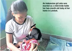  ??  ?? An Indonesian girl whowas marriedasa child bride holds her two-month-old babyat her homeinLomb­ok.