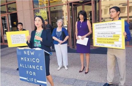  ?? JIM THOMPSON/JOURNAL ?? Executive Director of New Mexico Alliance for Life Elisa Martinez, second from left, calls for state Attorney General Hector Balderas to investigat­e or appoint a special prosecutor to investigat­e claims that abortion clinics in the state and the...