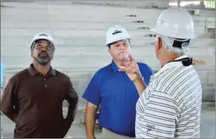  ?? FILE PHOTO ?? From left, Former Morrilton High School basketball player Donnie Parks and Shawn Halbrook, superinten­dent of the South Conway School District in Morrilton, listen to a story told by former Morrilton Devil Dogs assistant coach Johnny Hoyt during a tour...