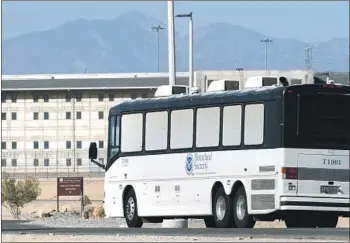  ?? James Quigg Associated Press ?? HOMELAND Security buses enter Victorvill­e Federal Correction­al Complex in San Bernardino County.