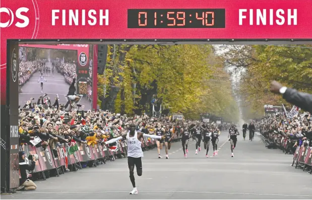  ?? Herbert Neubaue R/AFP/ Gett y Images ?? Elite runner Eliud Kipchoge of Kenya posted a record marathon time of 1:59.40 — in ideal conditions — in October 2019. But just how did he do it?