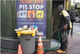  ?? Jessica Christian / The Chronicle 2019. ?? An attendant cleans out a restroom in the Tenderloin in November. Public Works crews don’t want to use the same toilets that homeless people use.