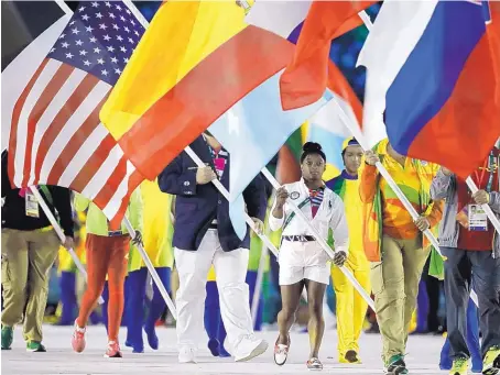  ?? MATT DUNHAM/ASSOCIATED PRESS ?? Simone Biles carries the flag of the United States during the closing ceremony on Sunday in the Maracana stadium in Rio de Janeiro.