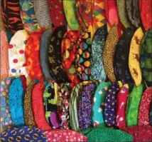  ?? GLENN GIBSON, THE CANADIAN PRESS ?? Brightly-coloured cloth caps can ease patient tension say doctors who wear them. A new study says they’re cleaner than paper hats.