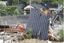  ??  ?? RESCUERS work at a house damaged by the heavy rain in Uwajima, Ehime Prefecture, Japan, in this photo taken by Kyodo on July 8.