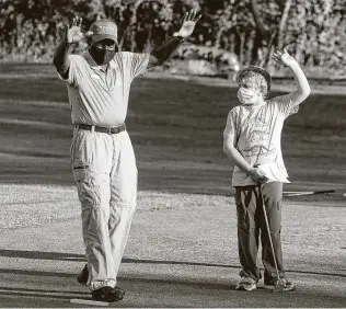  ?? Marvin Pfeiffer / Staff Photograph­er ?? Frederick Preston, 78, and Joseph Cameron, 10, celebrate a successful putt by Joseph in the First Tee Greater San Antonio program at the First Tee golf course on Nov. 11.