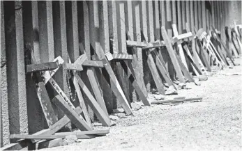  ??  ?? Crosses rest against the border fence in Nogales, where streams of migrants try to reach the USA.