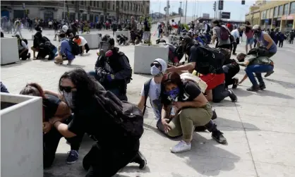  ?? Photograph: Matias Delacroix/AP ?? Anti-government protesters take cover just around the corner from the Congress building in Valparaiso.