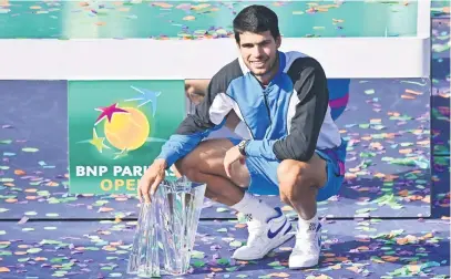  ?? Picture: AFP ?? WINNING FEELING. Spain’s Carlos Alcaraz with the championsh­ip trophy after beating Russia’s Daniil Medvedev in the final of the Indian Wells Masters at the Indian Wells Tennis Garden on Sunday night.