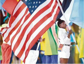  ?? Leon Neal / AFP/Getty Images ?? Spring’s Simone Biles joins 205 other flag bearers in Sunday’s Closing Ceremony for the Rio Games.