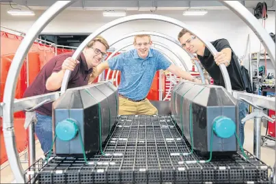  ?? SUBMITTED PHOTO ?? UPEI engineerin­g students Brett McDermott, left, Dylan MacIsaac and Jordan Sampson have invented a machine that gently guides heavy oyster cages in a rollercoas­ter-like flip. The process keeps oysters healthier and more valuable. The students received...