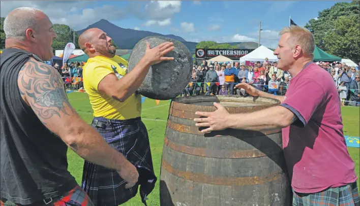  ?? 01_B32games18 ?? Tom Gilmore successful­ly lifts one of the McGlashan stones.