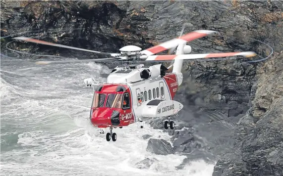  ?? Picture: Bob Sharples. ?? The rescue helicopter searches for the teenager. Teams local to the area continued to search for the 18-year-old yesterday, as the parameters were extended by the police further along the coastline.