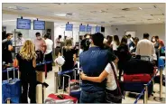  ?? AP ?? Travelers from Paraguay check in for a flight to Miami and a chance to receive the COVID-19 vaccine. Those with money are coming to the U.S. to avoid the long wait.