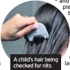  ??  ?? CLOSE contact can
A child’s hair being checked for nits
THESE often involve late nights, midnight feasts, getting cosy for the latest film, or crowding