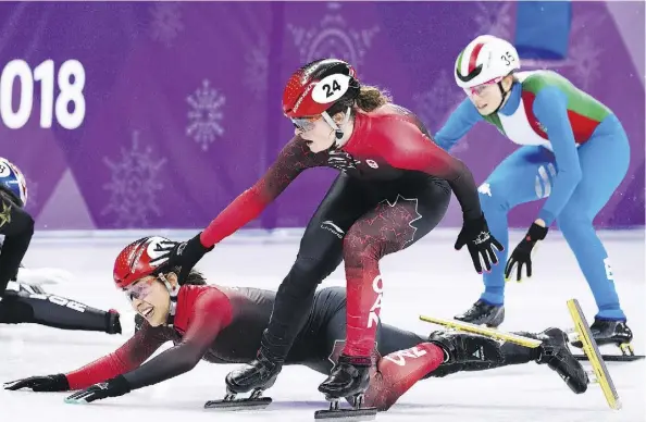  ?? NATHAN DENETTE/THE CANADIAN PRESS ?? Canada’s Valerie Maltais tumbles as teammate Kim Boutin tries to help her during the controvers­ial women’s 3,000-metre short-track speedskati­ng relay final. Canada’s disqualifi­cation was possibly due to an unintentio­nal infraction at the finish line.