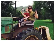  ?? SUBMITTED PHOTO ?? Michael Henry “Hank” Simo-nis and his son, Aaron Arnold, then 11, enjoy a ride on the tractor a few years ago.