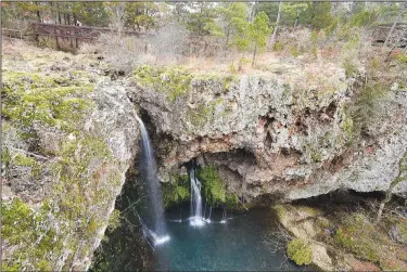  ?? NWA Democrat-Gazette/FLIP PUTTHOFF ?? A waterfall that plunges 70 feet is the centerpiec­e of attraction­s at Natural Falls State Park. Terry Stanfill takes in the view from a walkway above the waterfall.