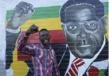  ?? TSVANGIRAY­I MUKWAZHI/THE ASSOCIATED PRESS ?? Terrence Chari mimics a painting of Zimbabwean President Robert Mugabe in Mbare Harare Monday. Lawmakers with the ruling Zanu-PF party gathered to meet on the fate of the longtime president.