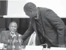  ?? Picture: SIMON MATHEBULA ?? COMRADES IN ARMS: Zwelinzima Vavi (standing) shakes Kgalema Motlanthe s hand at the 17th Annual Nedlac SummitSIBO­NGAKONKE SHOBA