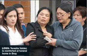  ??  ?? loss: Teresita Valdez is comforted at funeral home in Bray