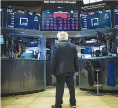  ?? AFPPIX ?? A trader stops and looks at the day's final numbers after the closing bell on the floor of the New York Stock Exchange on Tuesday.
