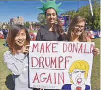  ?? AFPPIX ?? Students pose with their sign yesterday outside the site of the second US presidenti­al debate at Washington University in St Louis, Missouri.