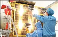  ??  ?? Engineers work on a satellite at Changguang Satellite Technology Co, based in Changchun, a major maker of commercial remotesens­ing satellites in China.