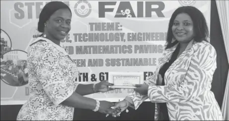  ??  ?? Shevion Sears (right), Public Relations Officer of Guyana Power and Light presenting a cheque to Regional Education Officer ag Tiffany Favourite Harvey.