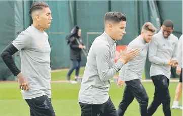  ??  ?? Liverpool’s Philippe Coutinho and Roberto Firmino during training in Liverpool, Britain. — Reuters