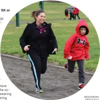  ?? MEDIANEWS GROUP FILE PHOTO ?? At right: A woman smiles as she runs alongside a young boy in Boyertown. This photo was taken before 2020.