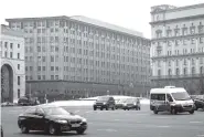  ?? ASSOCIATED PRESS FILE PHOTO ?? Cars pass the Federal Security Service headquarte­rs in December in downtown Moscow, Russia. A U.S. indictment of two Russian intelligen­ce agents and two hackers alleged to have stolen more than a half billion U.S. email accounts in 2014 has shone a...