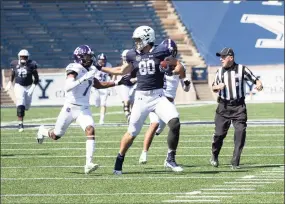  ?? Steve Musco / submitted photo ?? Yale tight end JJ Howland fends off Holy Cross defender John Smith during Saturday’s game.