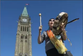  ?? ADRIAN WYLD, THE CANADIAN PRESS ?? Chief Marcia Brown Martel, who was placed in the foster system for Indigenous children in the 1960s, sings outside the Parliament Buildings on Friday after a government news conference announcing a compensati­on package.
