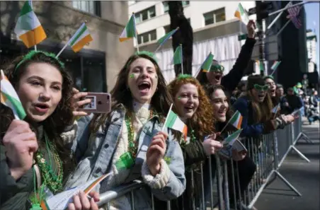  ?? CRAIG RUTTLE — THE ASSOCIATED PRESS ?? Spectators cheer as they take part in the St. Patrick’s Day parade Saturday in New York. Several bagpipe bands led a parade made up of over 100 marching bands after Democratic Gov. Andrew Cuomo spoke briefly, calling it a “day of inclusion” and adding:...