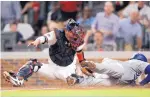  ?? JOHN BAZEMORE/ASSOCIATED PRESS ?? Atlanta catcher Kurt Suzuki tags out Matt Kemp of Los Angeles during the sixth inning of Game 3 of their NL Division Series.