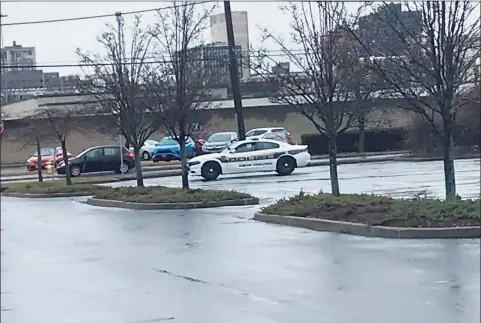  ?? Luther Turmelle / Hearst Connecticu­t Media ?? A police cruiser sits in the mostly empty parking lot at IKEA in New Haven on Saturday morning.