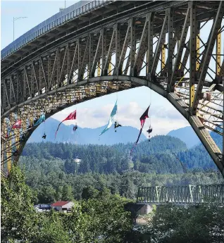  ?? NICK PROCAYLO ?? As protesters hung from the Ironworker­s Memorial Bridge in Vancouver to block oil tanker traffic, word was getting out that work on the Trans Mountain pipeline is starting up again.