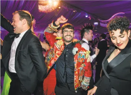  ?? Photos by Laura Morton / Special to The Chronicle ?? Robert Fowler (left), John Vlahides and Torreya Cummings dance at the party after Thursday’s Symphony opener.