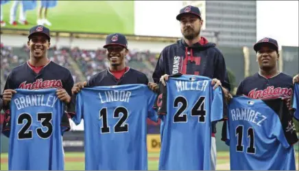  ?? DAVID DERMER — THE ASSOCIATED PRESS ?? Michael Brantley, Francisco Lindor, Andrew Miller and Jose Ramirez show their All-Star jerseys before playing the Tigers on July 10 at Progressiv­e Field.