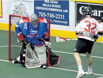  ?? JASON BAIN/EXAMINER ?? Peterborou­gh Century 21 Lakers' goalie Evan Kirk makes a save on Mitch McMichael (32) of the Brooklin Redmen during the first period of Game 3 of their Major Series Lacrosse semi-final at the Memorial Centre on Tuesday night. The Lakers won 9-8 in...