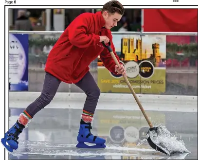  ??  ?? Making a splash: Staff at the outdoor rink in Lincoln clear water away after ice began to melt