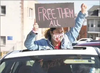  ?? Ned Gerard / Hearst Connecticu­t Media ?? A woman gestures from a car during a protest outside the Bridgeport Correction­al Center on April 15.