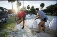  ?? AP PHOTO ?? Filling sandbags with sand provided by the City of Tybee Island, Sib McLellan, left, and his wife, Lisa McLellan, prepare for Hurricane Florence, Wednesday, Sept., 12 , on Tybee Island, Ga.