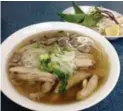  ??  ?? Banh Cuon Pho Ga’s soup is garnished with sliced onions and baby cilantro.