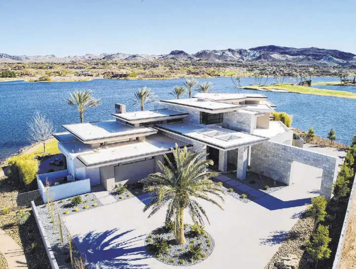  ?? Synergy/Sotheby’s Internatio­nal Realty ?? Sited on a 1.2-acre lot at Lake Las Vegas, the two-story, 8,838-square-foot, four bedroom, desert contempora­ry home is listed for $7.5 million.