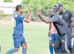 ?? IAN ALLEN/PHOTOGRAPH­ER ?? Tyrique Wilson (left) of Molynes United celebrates with coach Jermaine Thomas (right) after scoring his team’s second goal against Humble Lion during their Jamaica Premier League football match at the Stadium East field yesterday. Molynes United won 3-2.