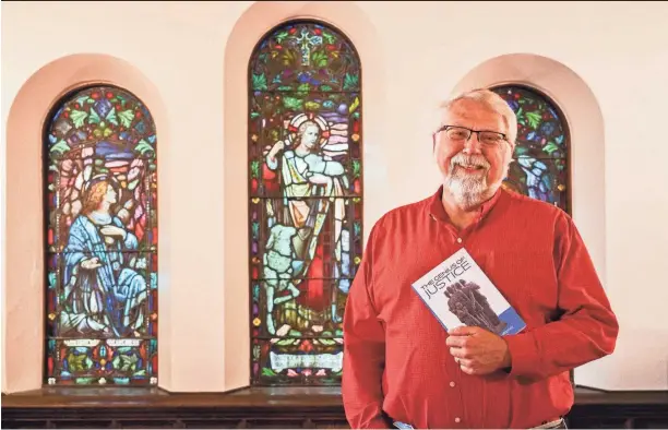  ?? PETER GILL/COLUMBUS DISPATCH ?? The Rev. Tim Ahrens of of the First Congregati­onal Church downtown has written “The Genius of Justice,” a book examining the lives and lessons of 53 faith and other social justice leaders from Columbus and beyond.