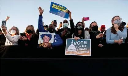  ?? Photograph: Jim Watson/AFP/Getty Images ?? Supporters of Jon Ossoff and the Rev Raphael Warnock in Atlanta, Georgia, on 4 January.